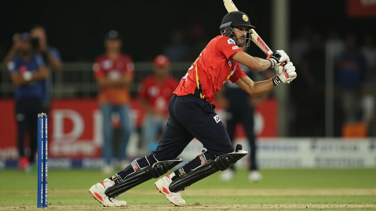 Close view of an IPL batter mid-shot at the crease with the ball near the bat and fielders visible in the background